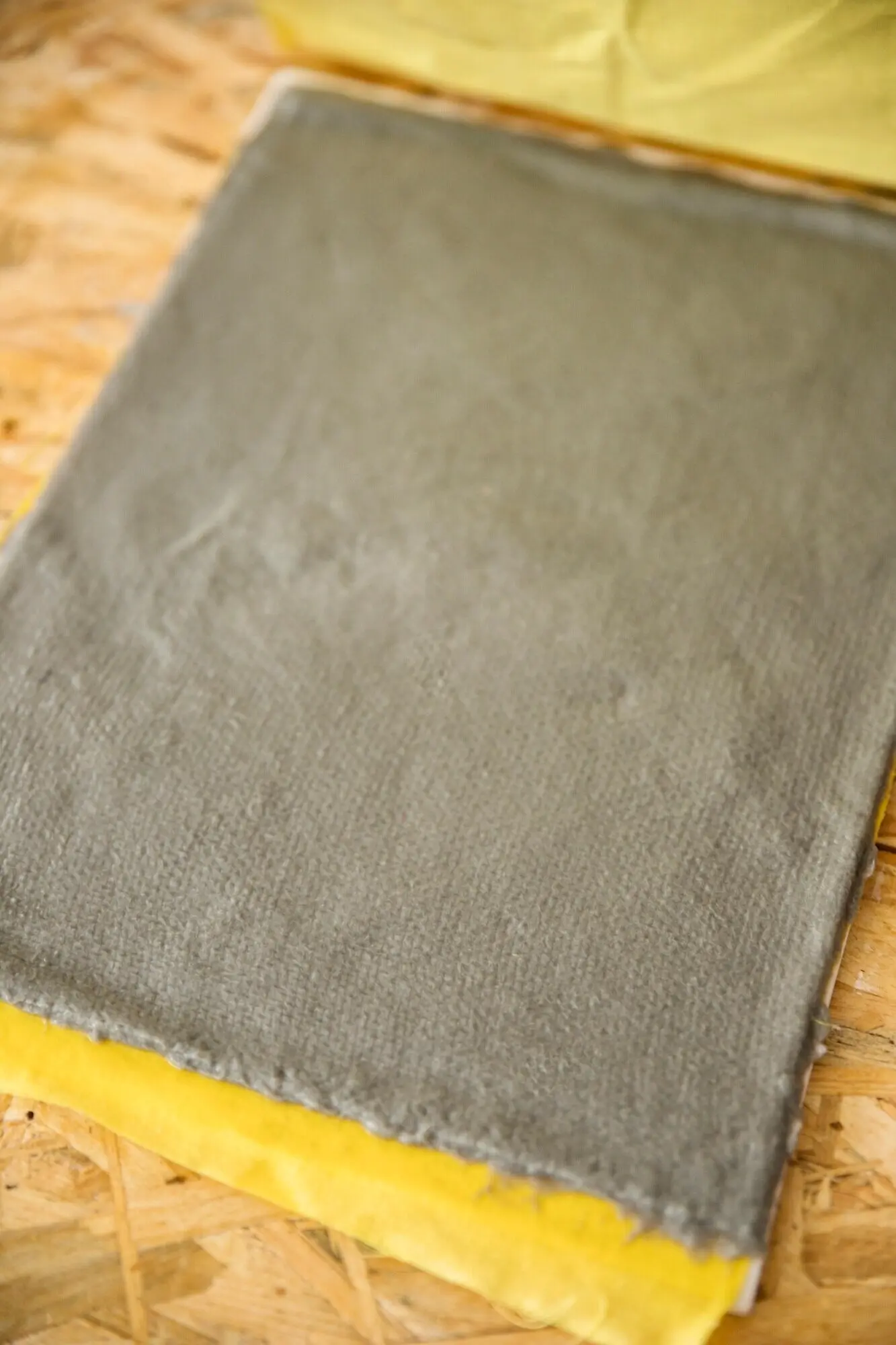 A close-up view of grey-colored paper pulp